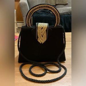Evening black n gold bag with round handle and string for cross body bag.